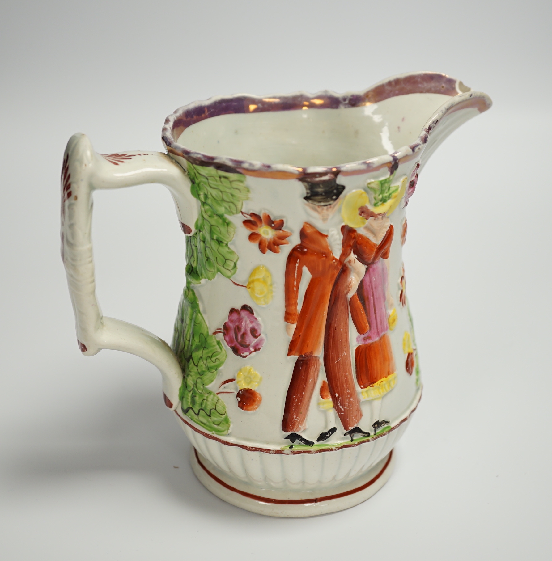 A relief moulded 19th century Staffordshire pearlware jug, 15cm high